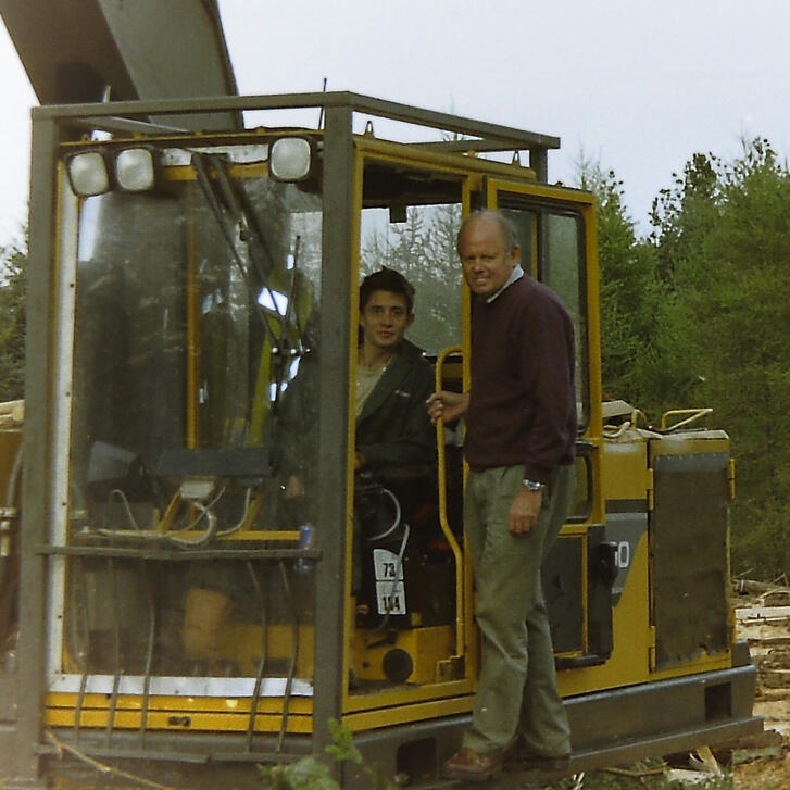 forest harvester The maker Nick sits alongside his father on the side of his forest harvesting machine, the appearance is of an old style excavator